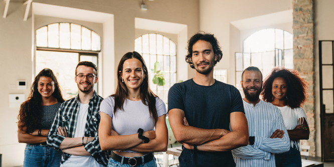 Image of Gen Z-aged men and women standing in front of a window
